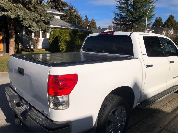 White pickup truck with a retractable tonneau cover 